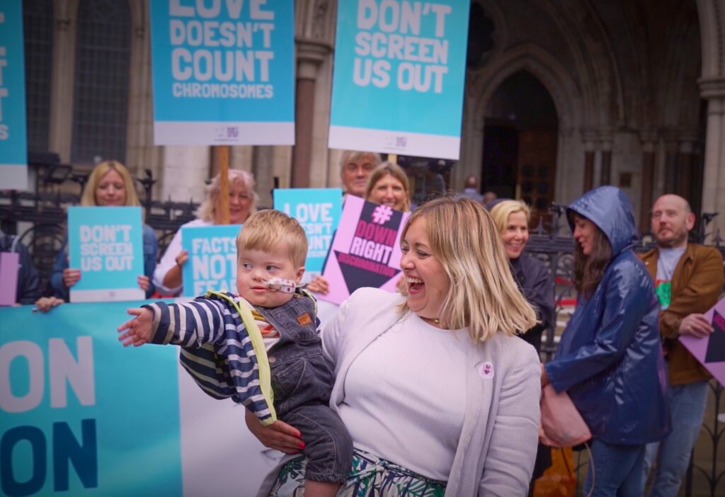 Maire and her toddler Aidan join the demonstration outside the Royal Courts of Justice